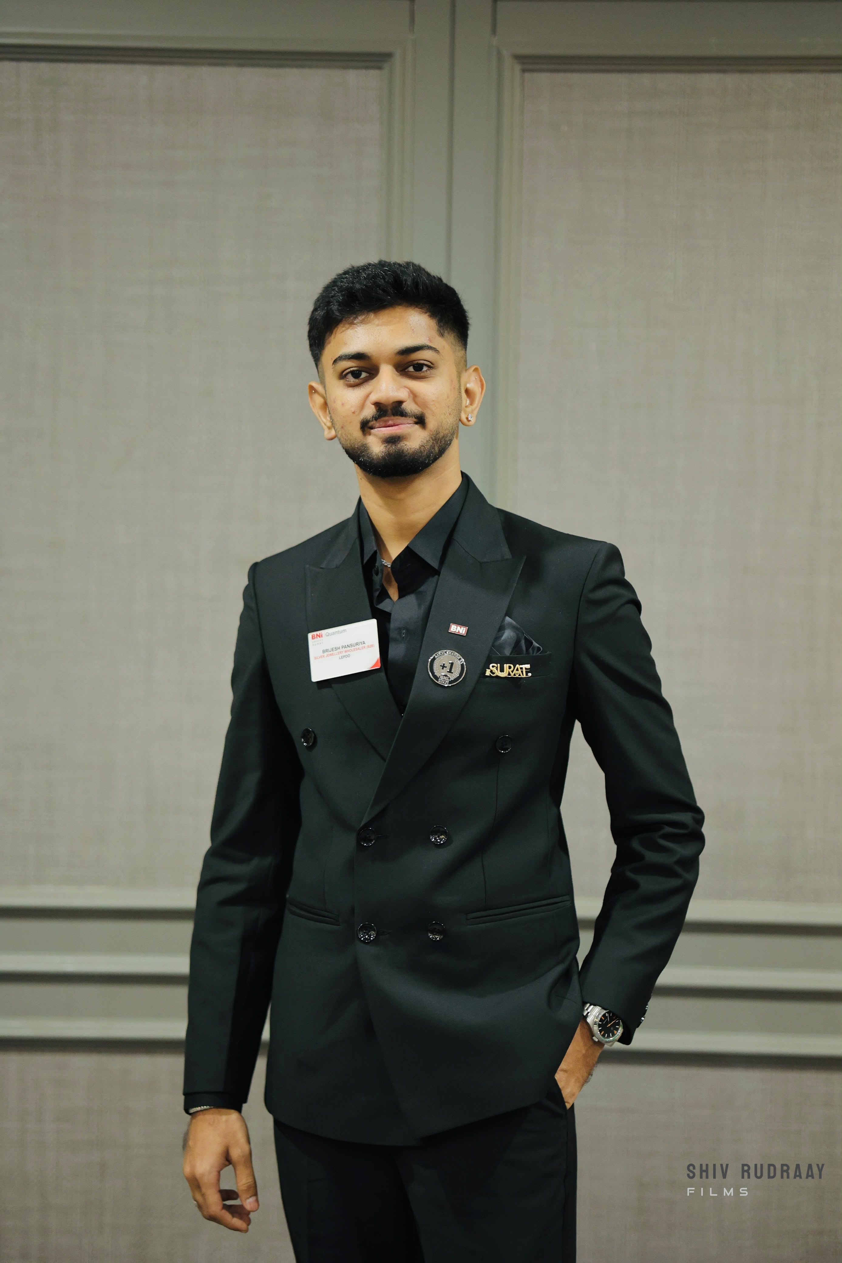 Brijes Pansuriya in a black suit at a BNI Quantum event